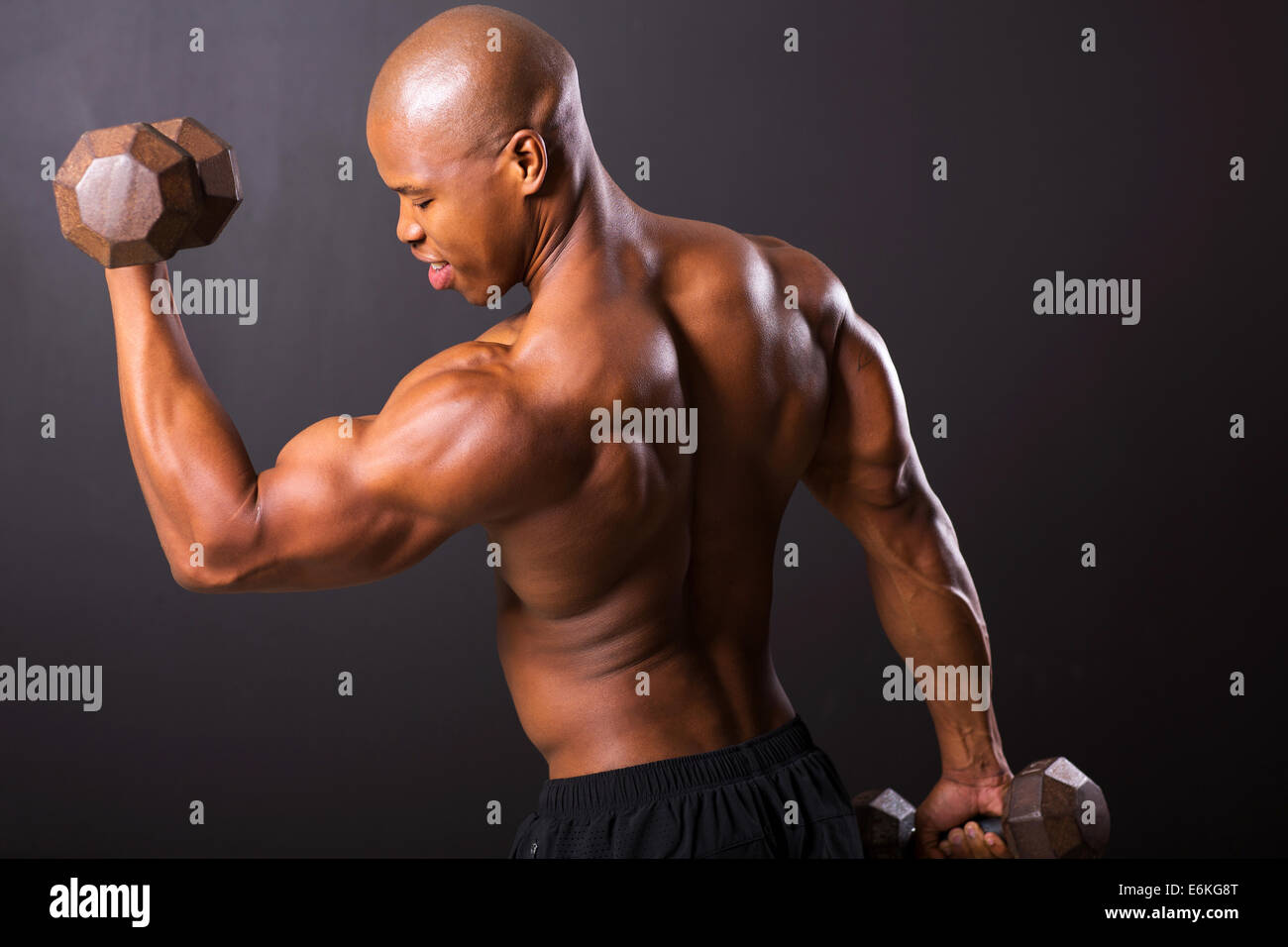 African male bodybuilder doing heavy weight exercise Stock Photo