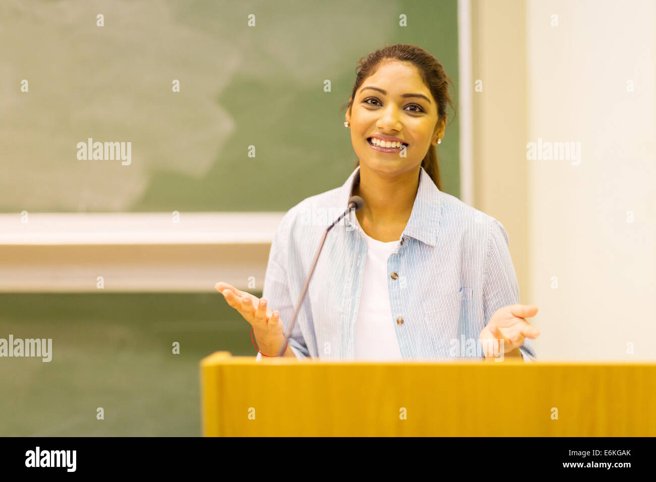 pretty Indian female college student giving a speech in lecture hall Stock Photo