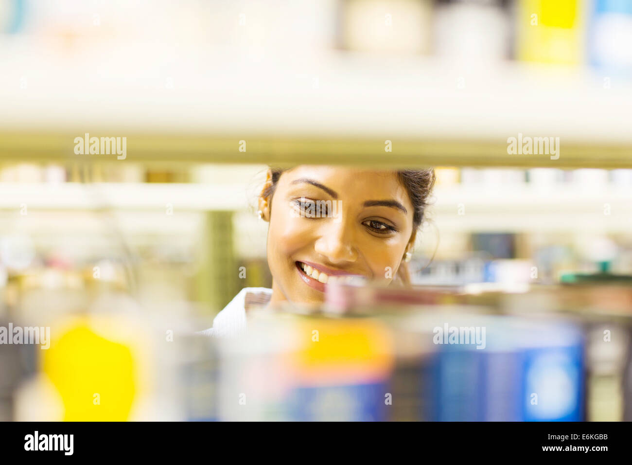 attractive young female college student in library looking for books Stock Photo