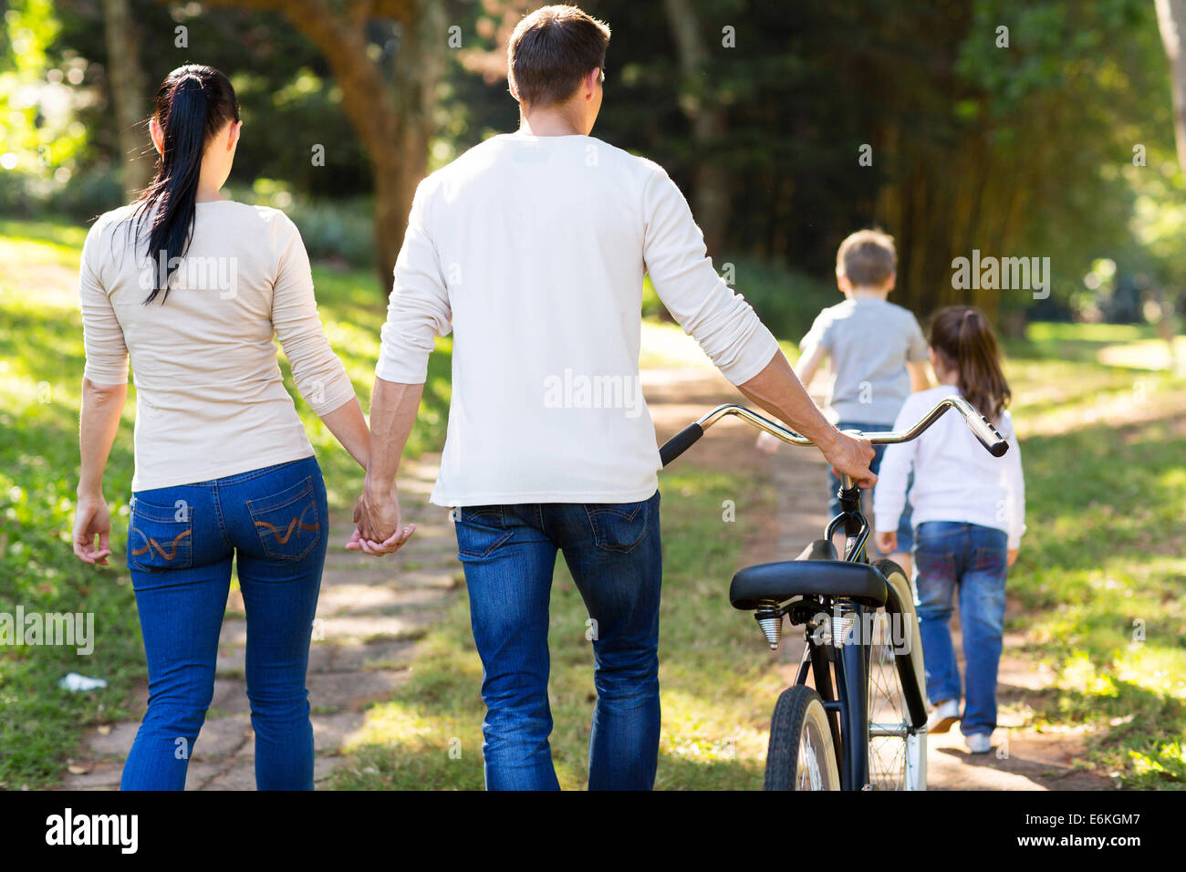 rear view of young family walking outdoors Stock Photo