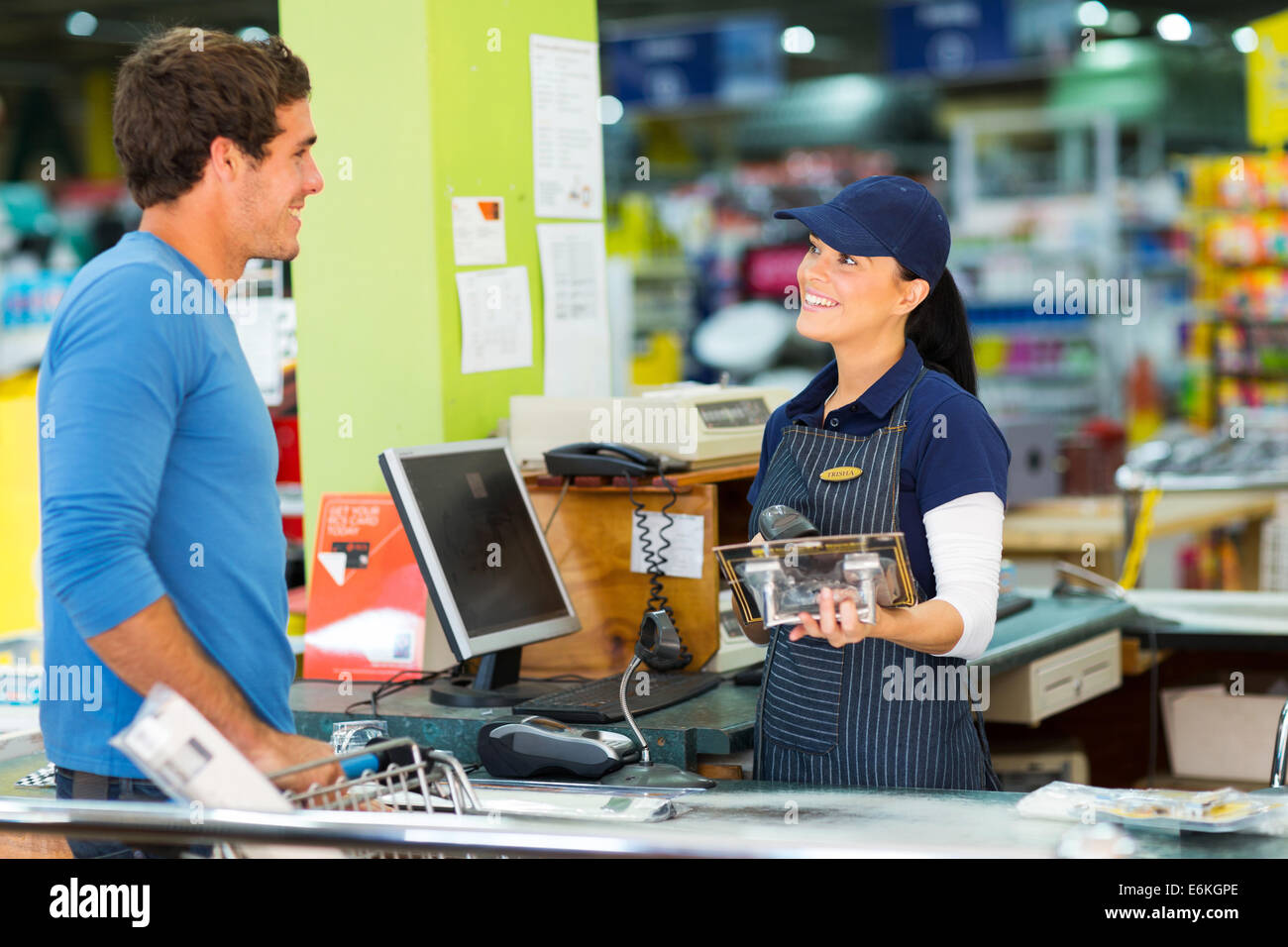 young man paying at till point in hardware store Stock Photo