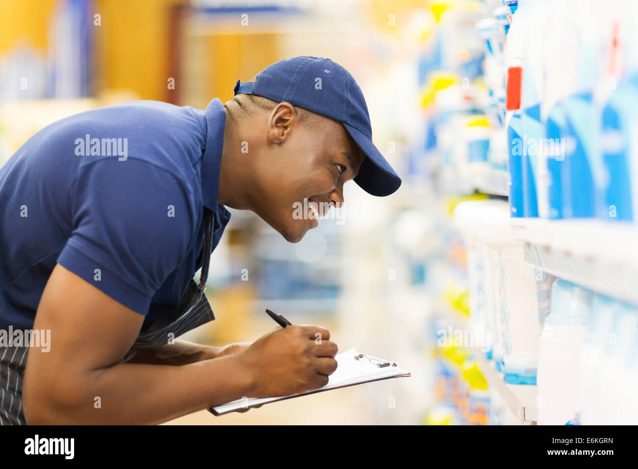 cheerful African hardware store worker taking stock Stock Photo Alamy