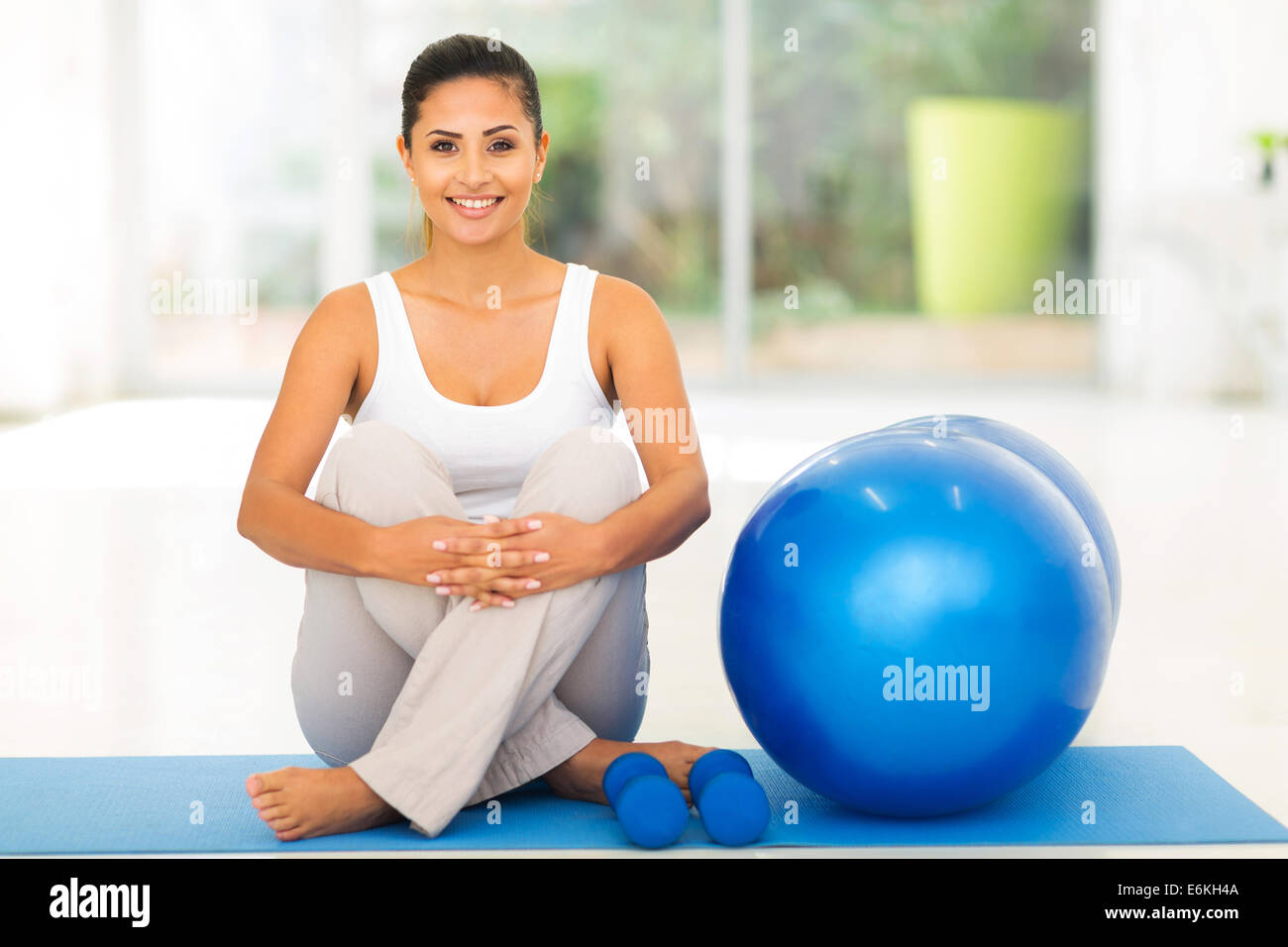 gorgeous young woman sitting on mat with exercise ball Stock Photo - Alamy