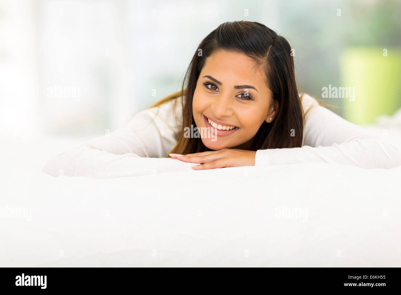 pretty woman lying on bed at home Stock Photo