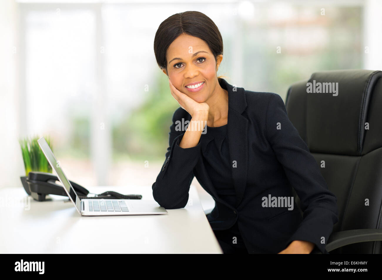 beautiful mature African businesswoman relaxing in office Stock Photo ...