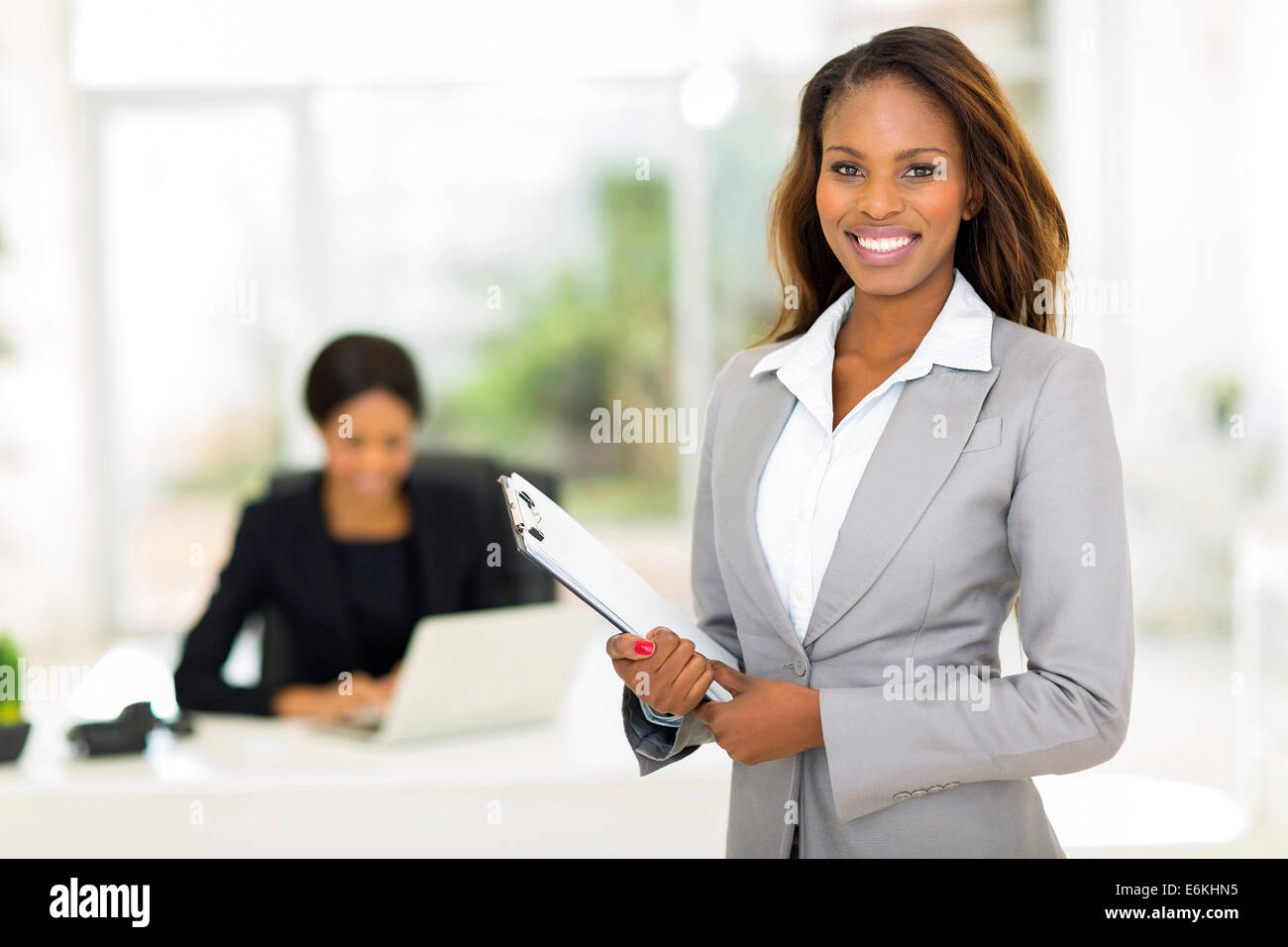 beautiful African businesswoman holding clipboard Stock Photo - Alamy