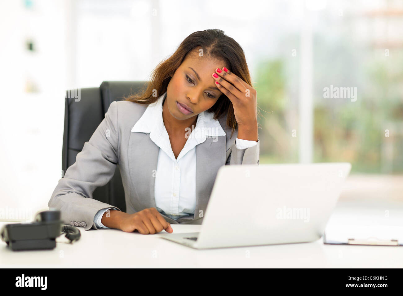 sad African American businesswoman sitting in modern office Stock Photo ...