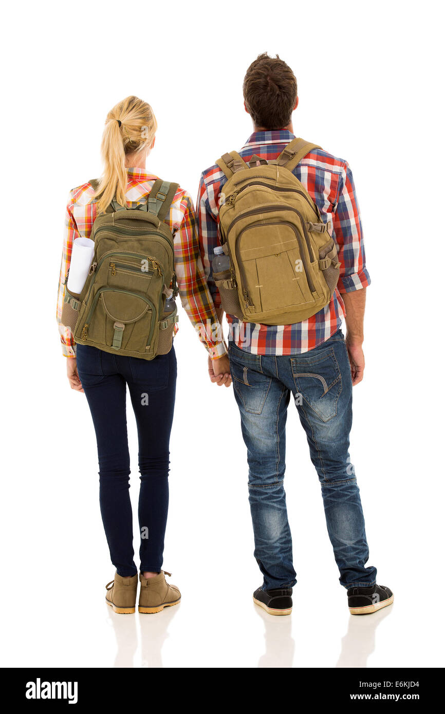 rear view of hiking couple holding hands isolated on white background Stock Photo