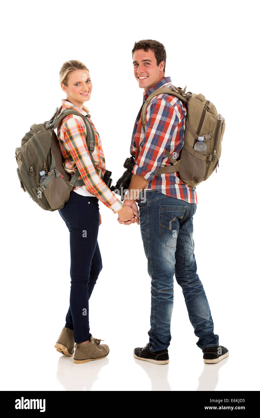 happy young couple with backpacks looking back on white background Stock Photo