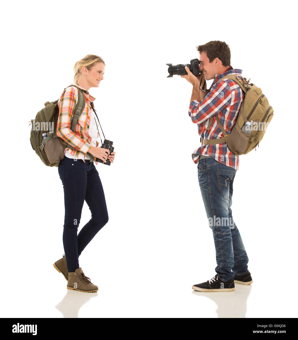 man taking photo of happy girlfriend on white background Stock Photo