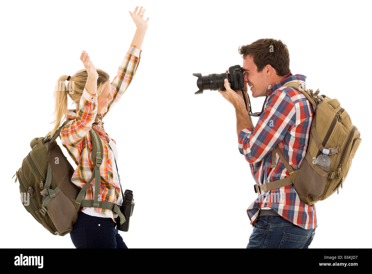 happy young man photographing his girlfriend isolated on white Stock Photo