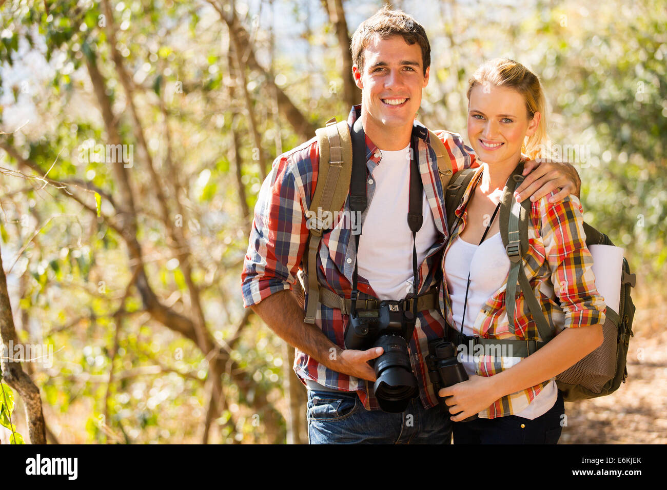 happy young couple hiking in autumn forest Stock Photo - Alamy