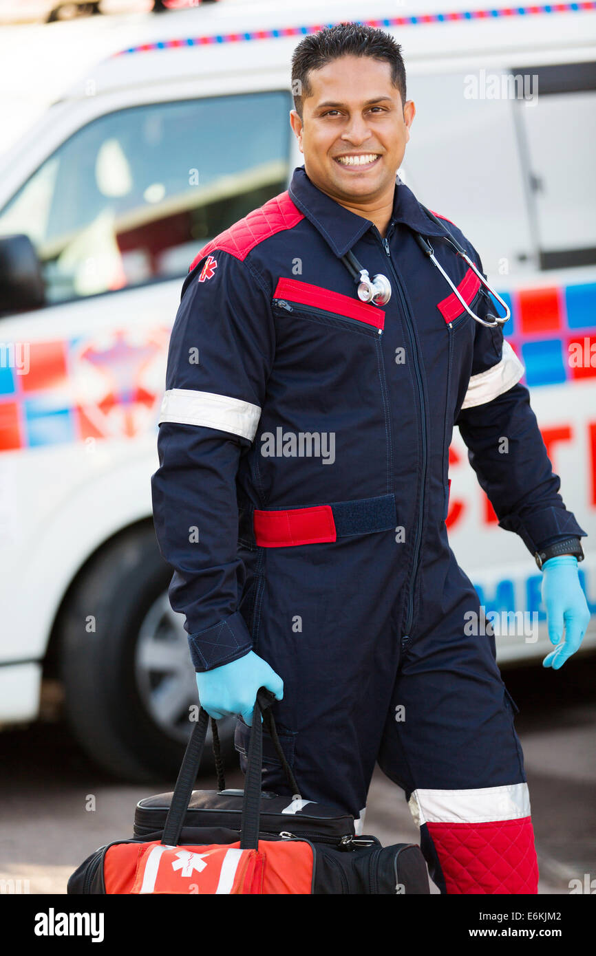 handsome young paramedic carrying portable equipment Stock Photo