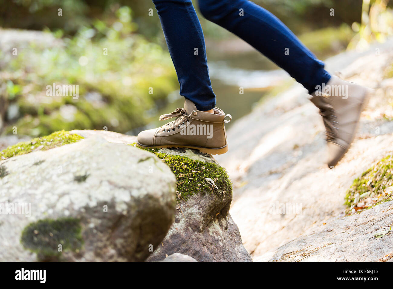 young woman wearing hiking boots mountain climbing Stock Photo