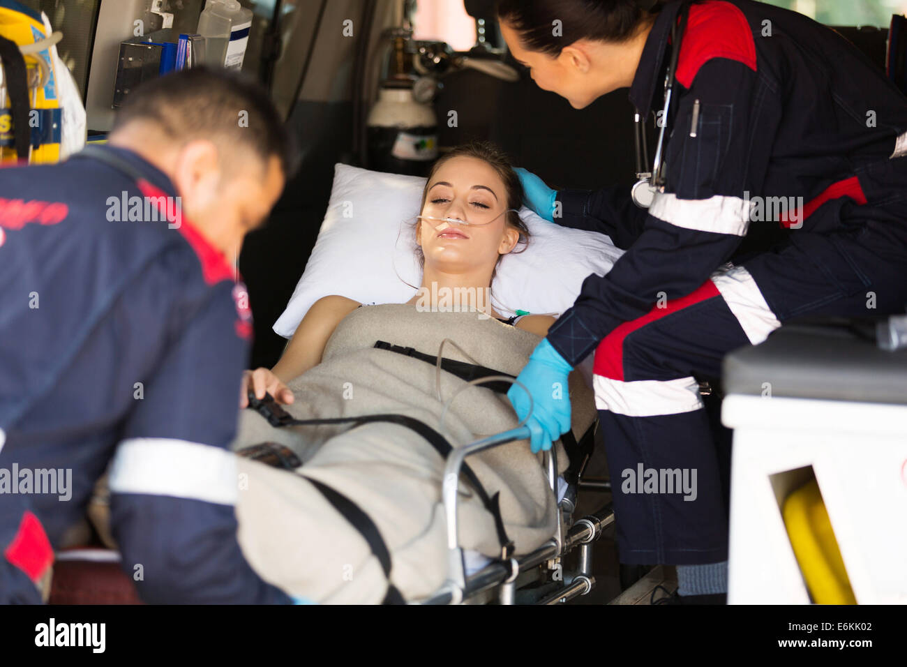 caring paramedic comforting sick patient on ambulance Stock Photo