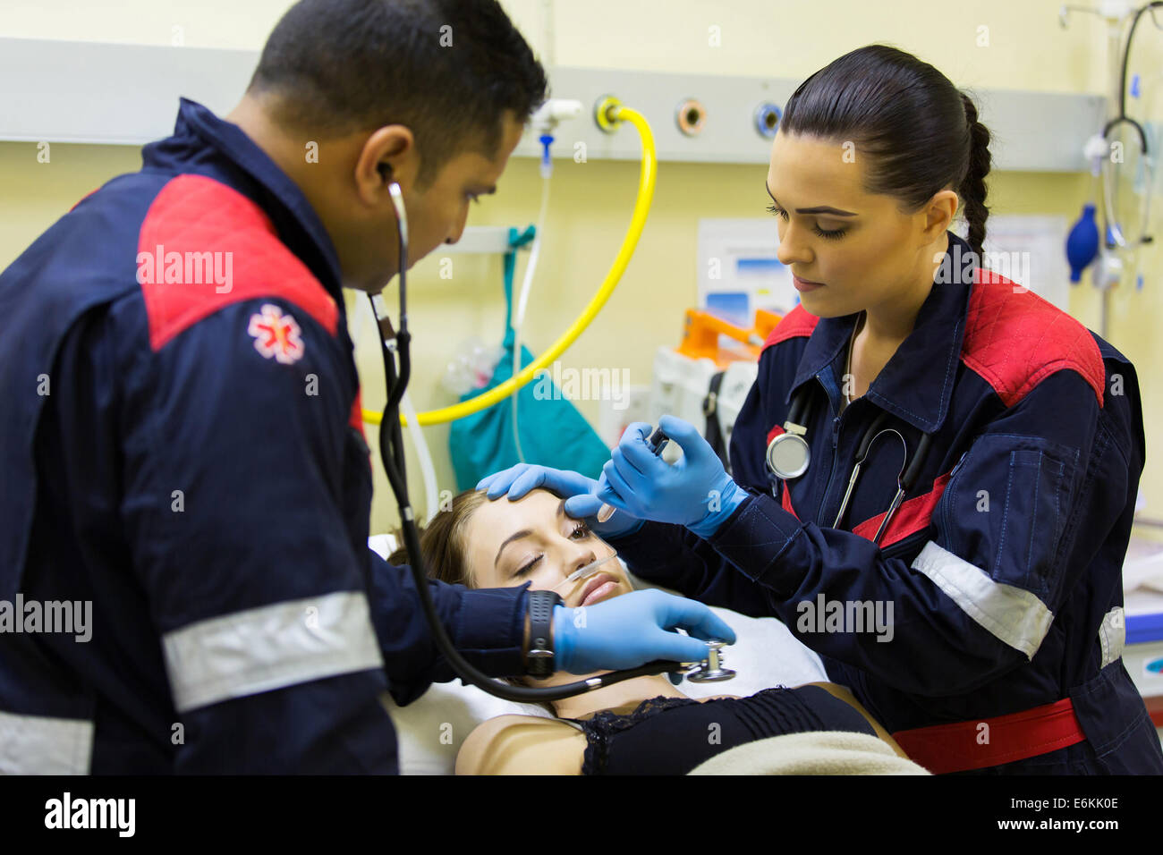 paramedics examining female patient in hospital Stock Photo