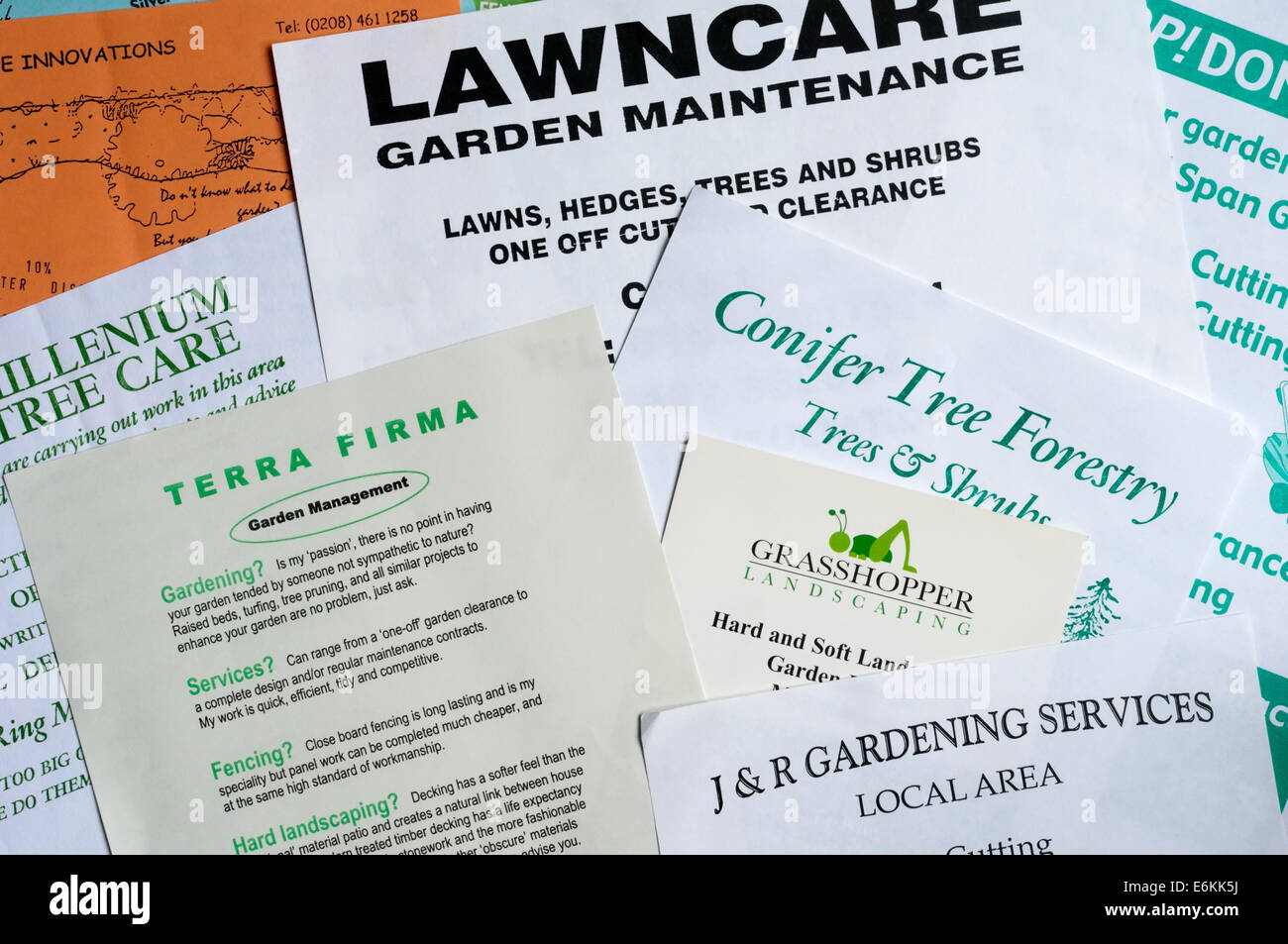 Junk mail leaflets delivered door to door from small or one-man businesses seeking gardening or tree work. Stock Photo
