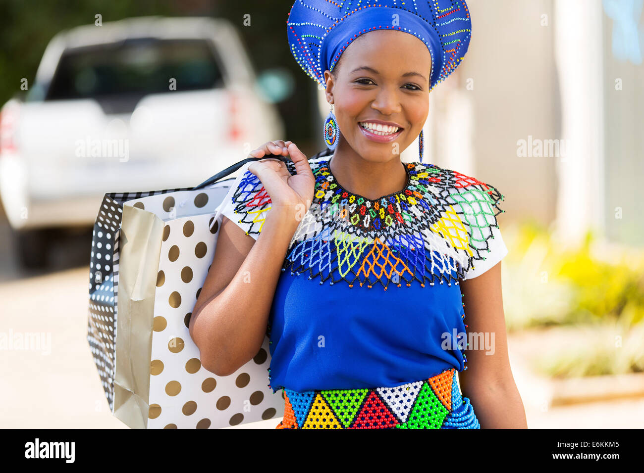 cheerful African young lady in shopping mall Stock Photo