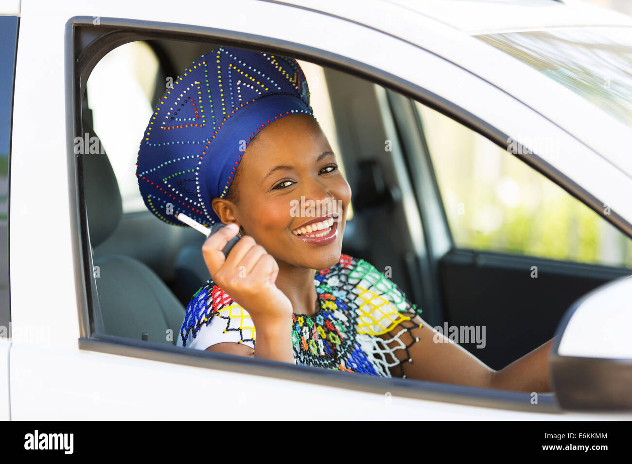 happy black woman showing car key inside her new vehicle Stock Photo