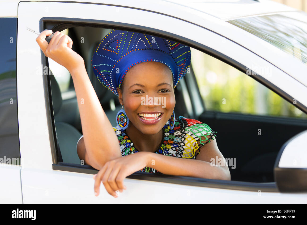 pretty young south African woman showing a car key inside her new vehicle Stock Photo
