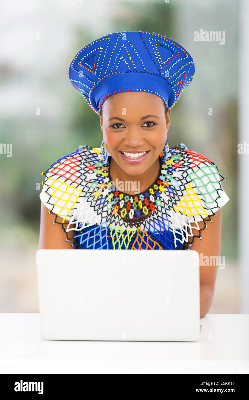 pretty south African woman using laptop computer at home Stock Photo