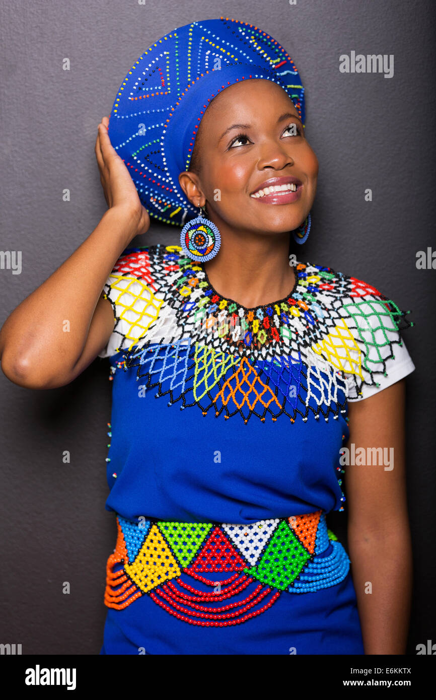 pretty young African woman looking up on black background Stock Photo