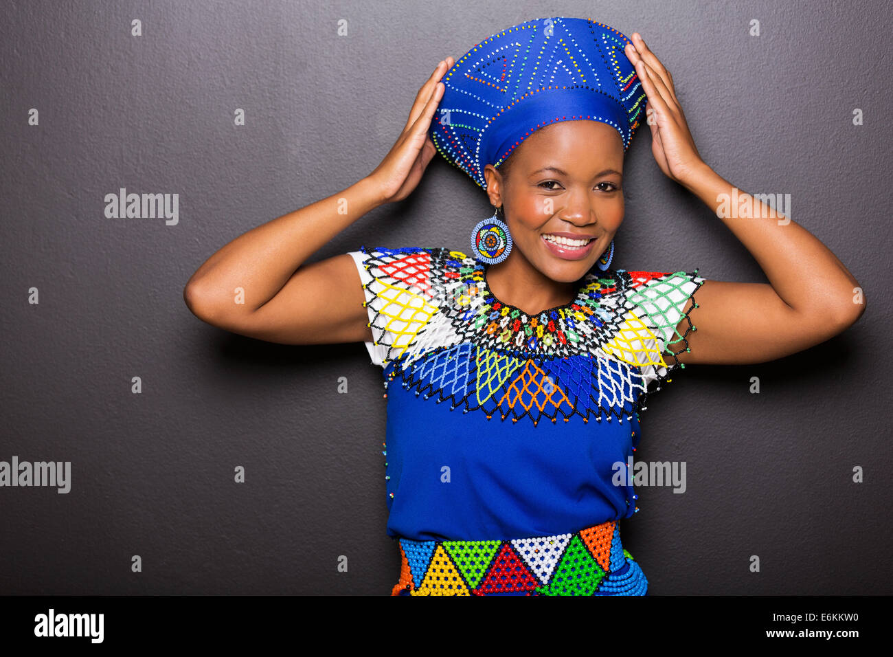 beautiful African model in traditional attire posing on black background Stock Photo