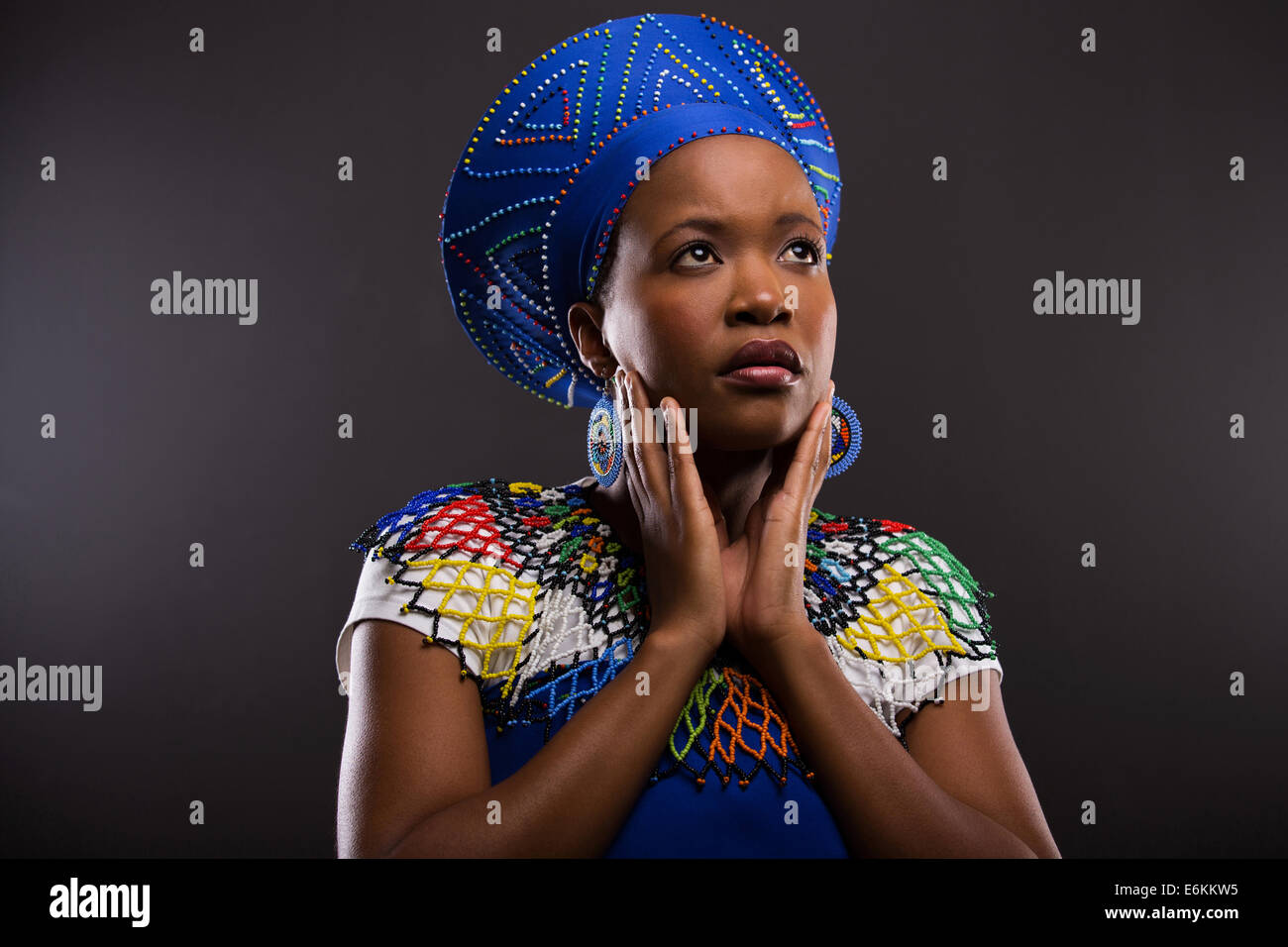 thoughtful African zulu woman looking up isolated on black background Stock Photo