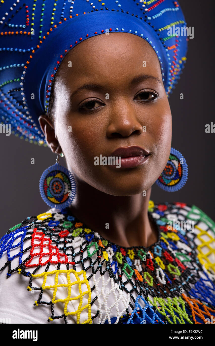 beautiful young African Zulu lady looking at the camera on black background Stock Photo