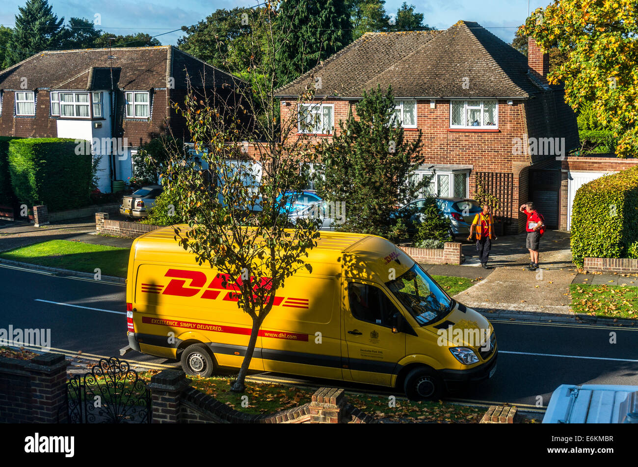 Parkef DHL delivery van, with the driver chatting to a postman outside