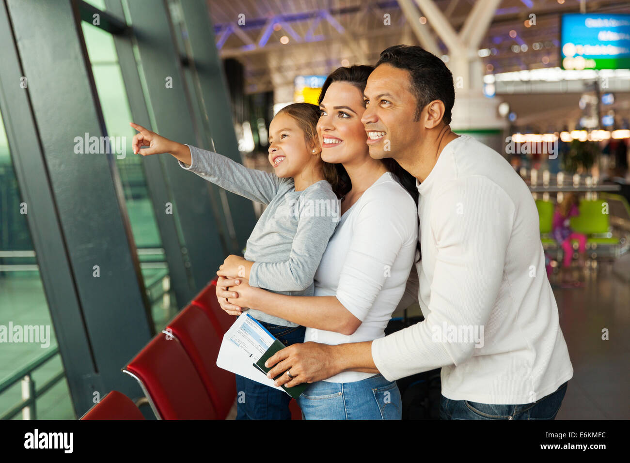 happy little girl and parents waiting at airport Stock Photo