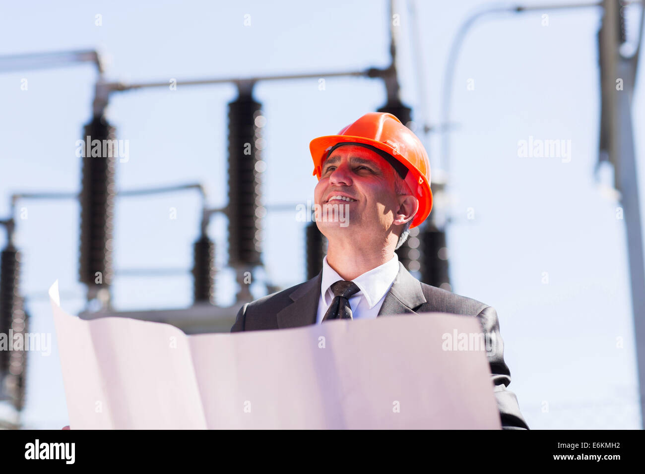 mid age industrial manager working in electric substation Stock Photo