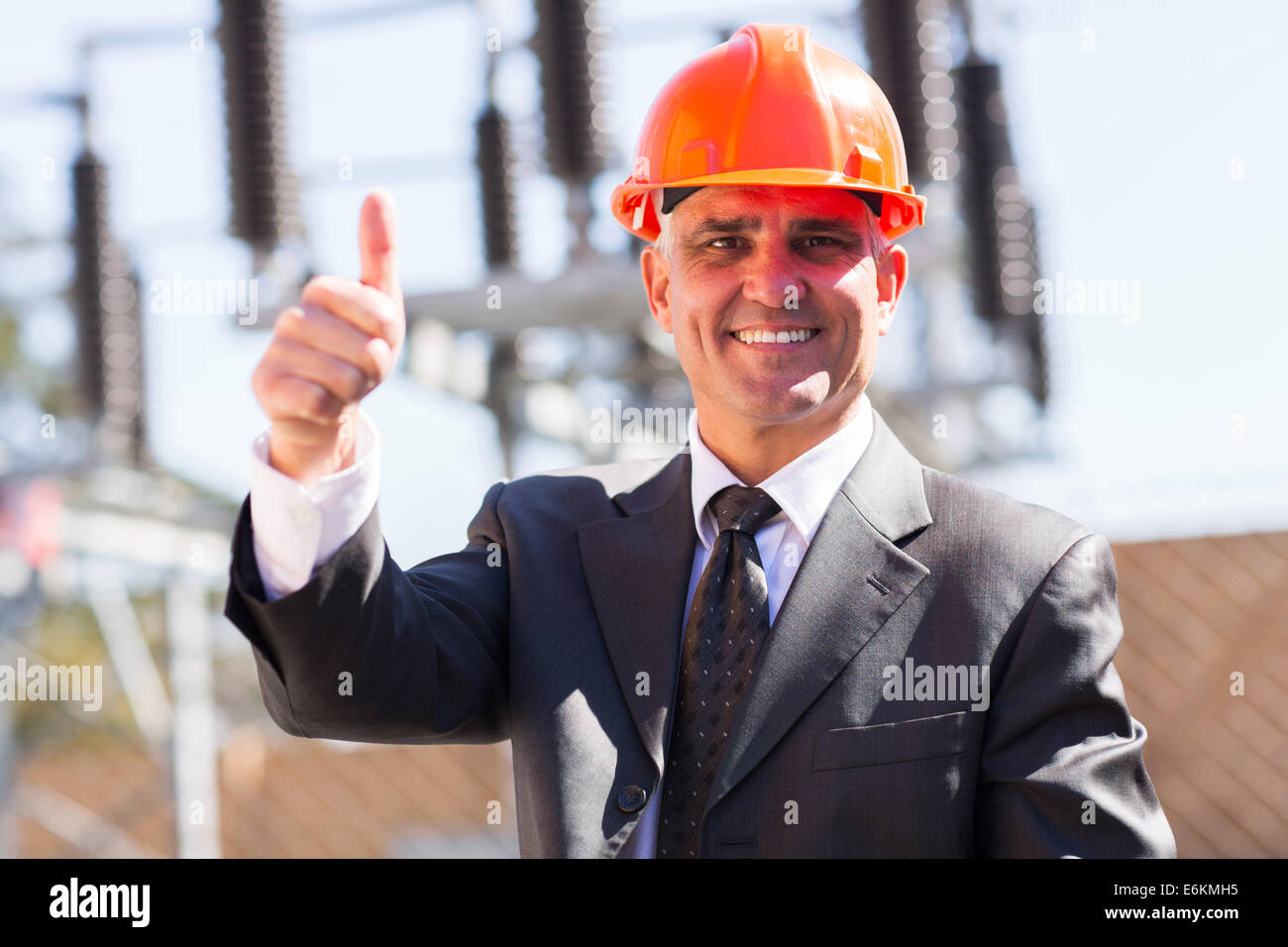 portrait of happy middle aged male industrial manager giving thumb up at substation Stock Photo