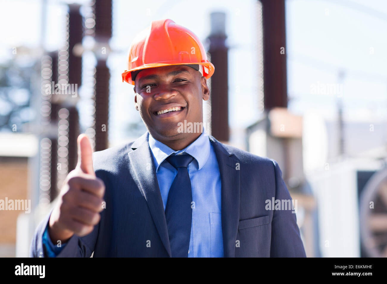 happy African industrial manager with thumb up at substation Stock Photo