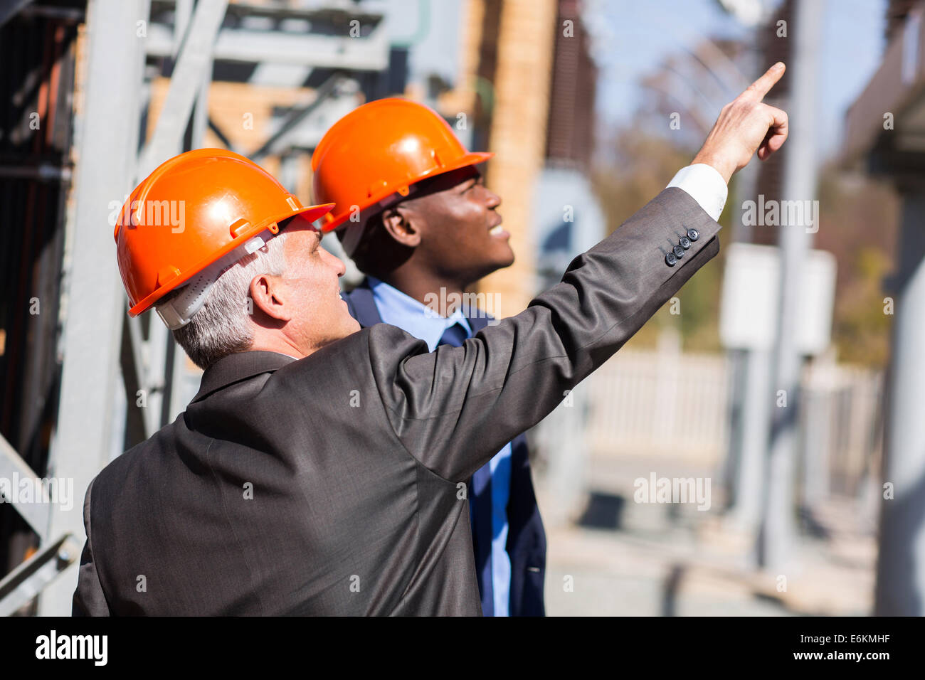 two male industrial managers working in electricity power plant Stock Photo