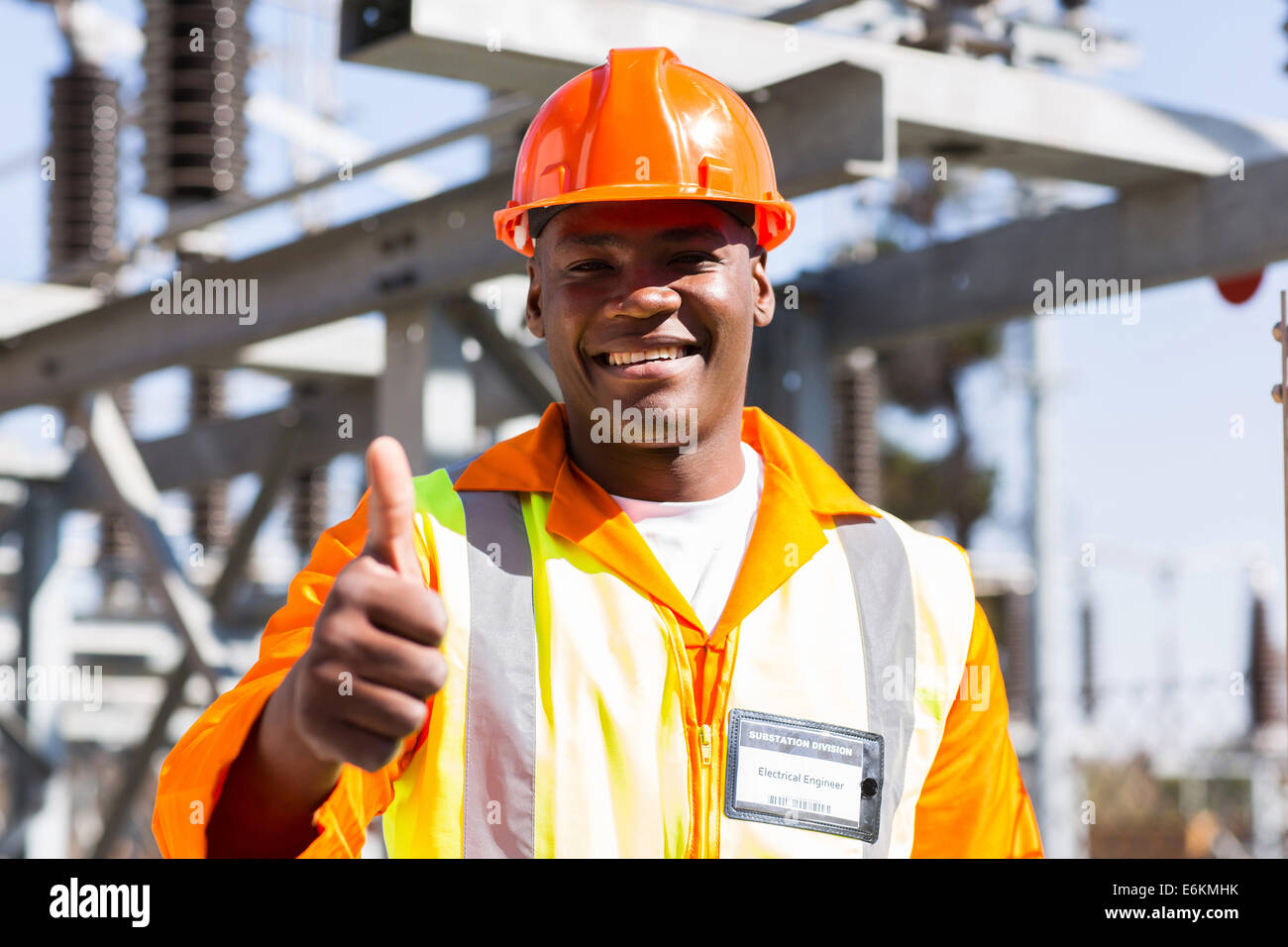 portrait of African electrician with thumb up at substation Stock Photo