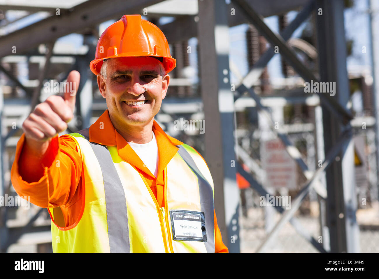 middle aged electrician giving thumb up in substation Stock Photo