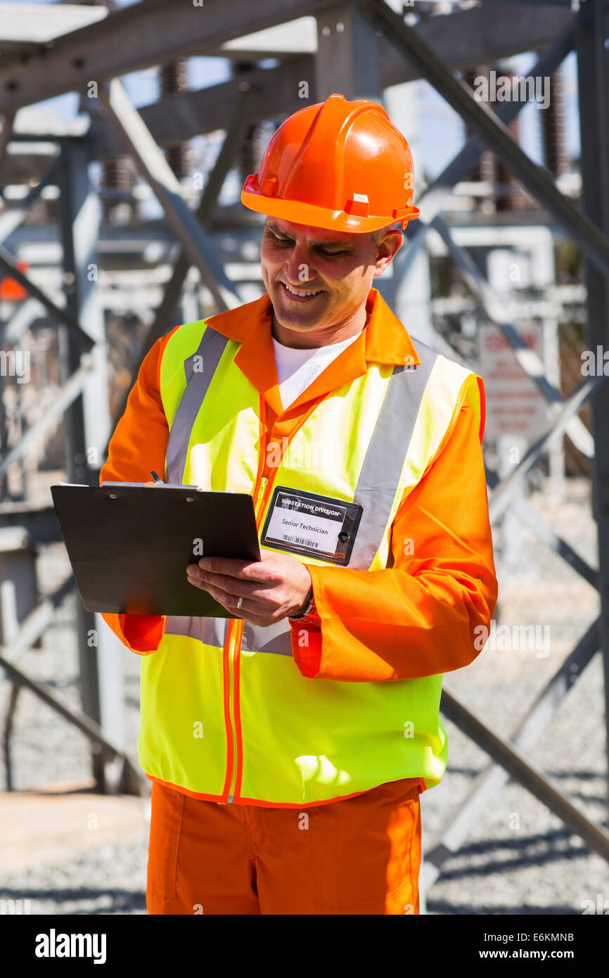 senior industrial technician taking readings in power plant Stock Photo