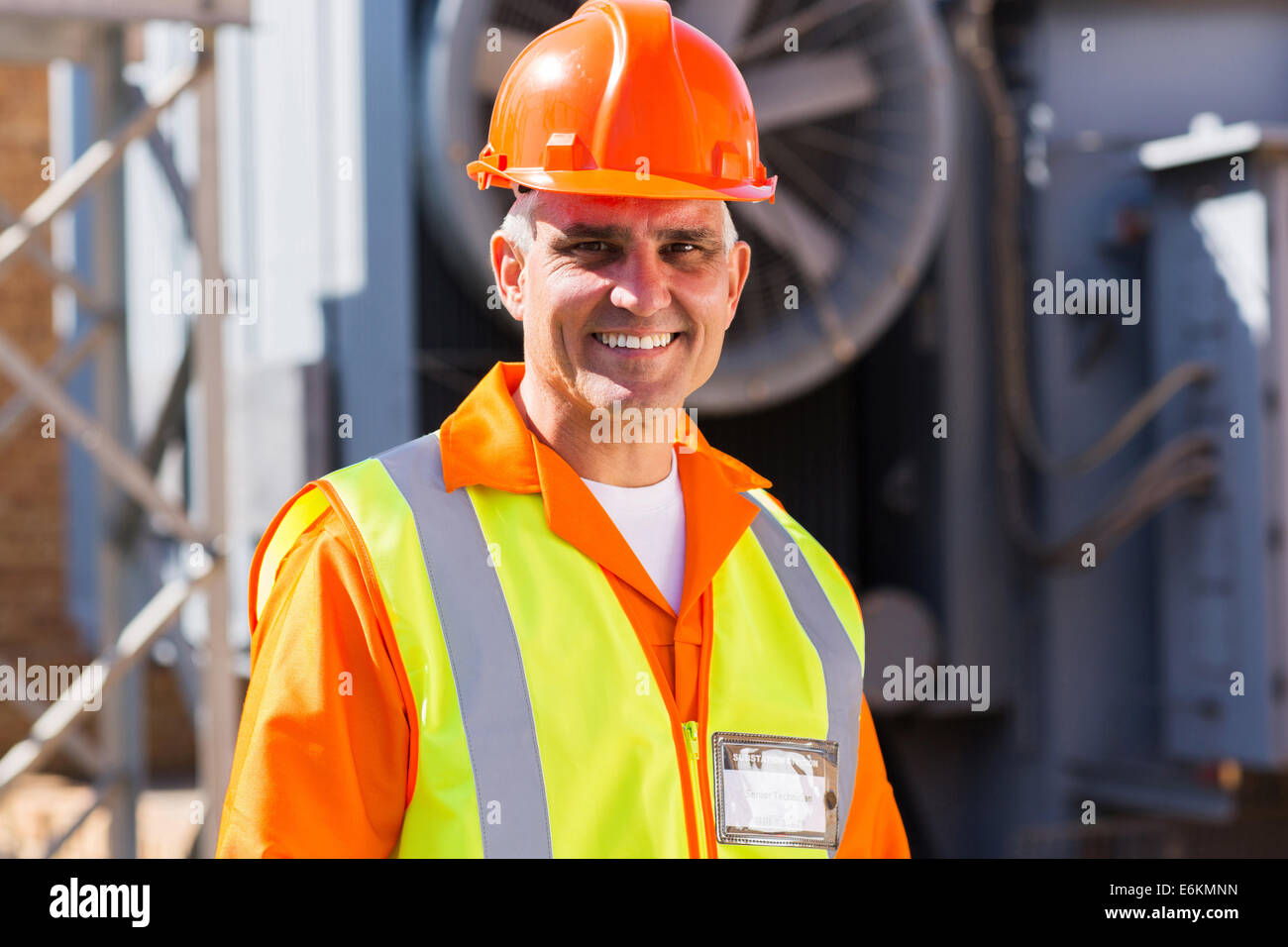 handsome mid age male electrician in electrical substation Stock Photo