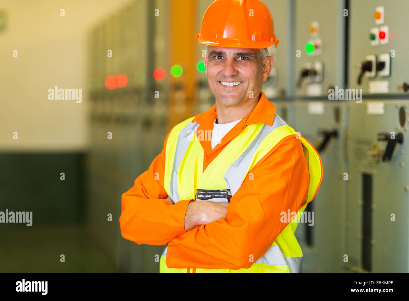 portrait of handsome middle aged electrical engineer with arms crossed