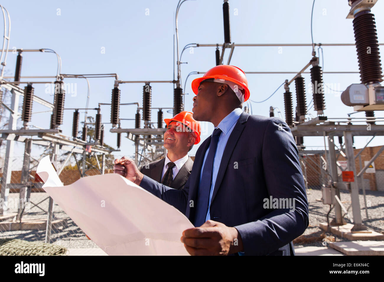 industrial managers working in electric substation Stock Photo