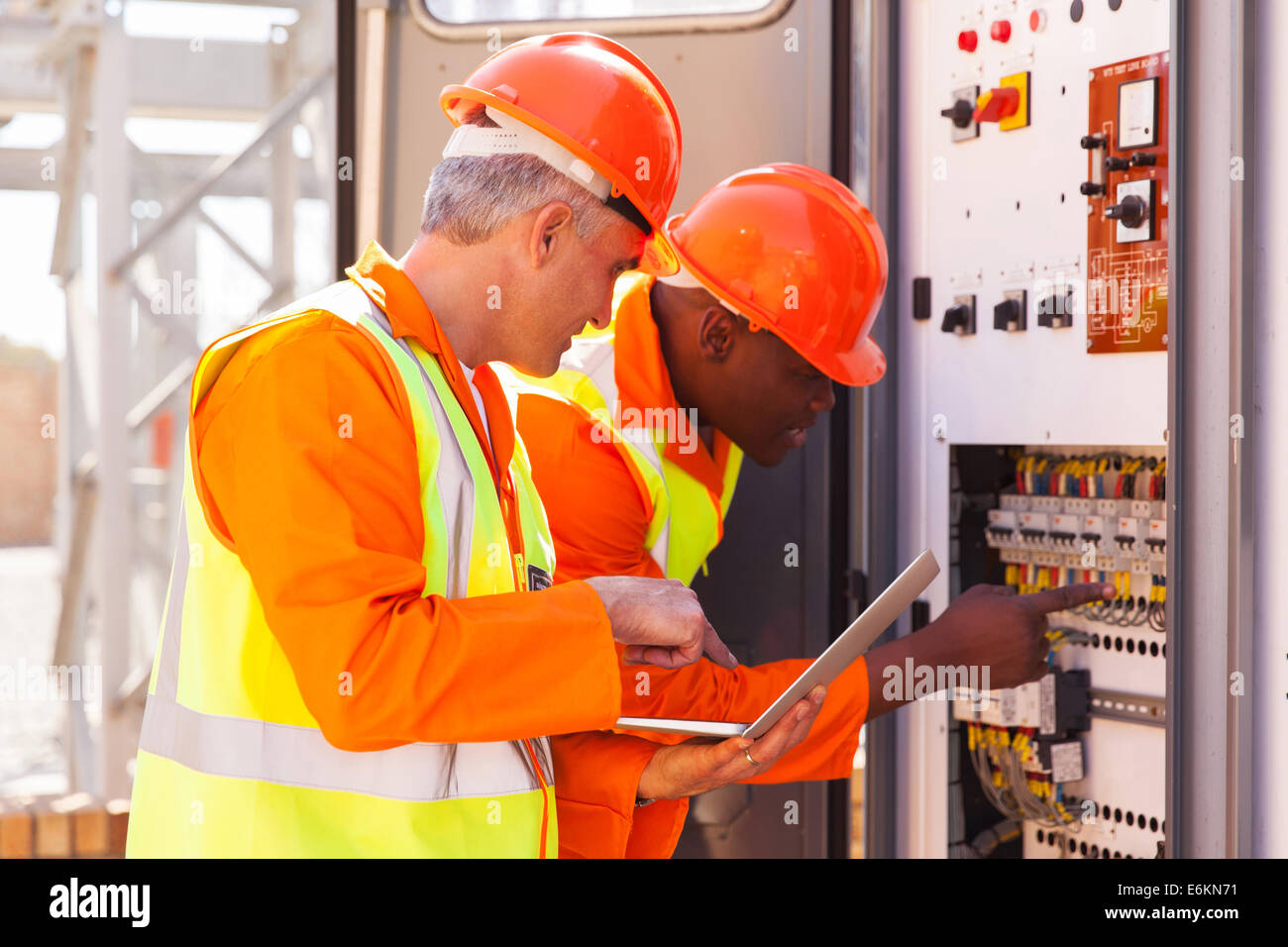 two experienced industrial technicians checking transformer Stock Photo