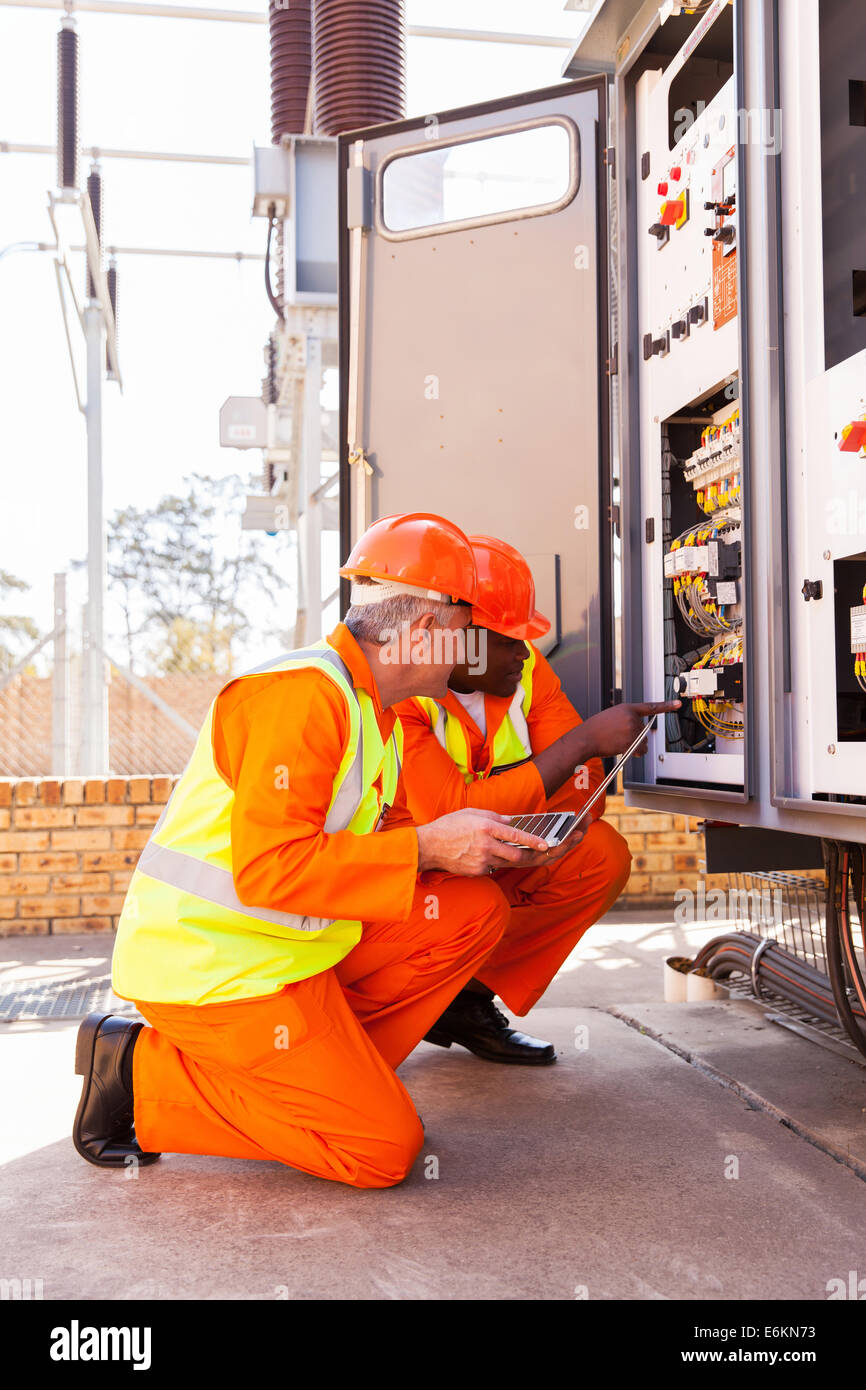 modern industrial engineers working in electric substation Stock Photo