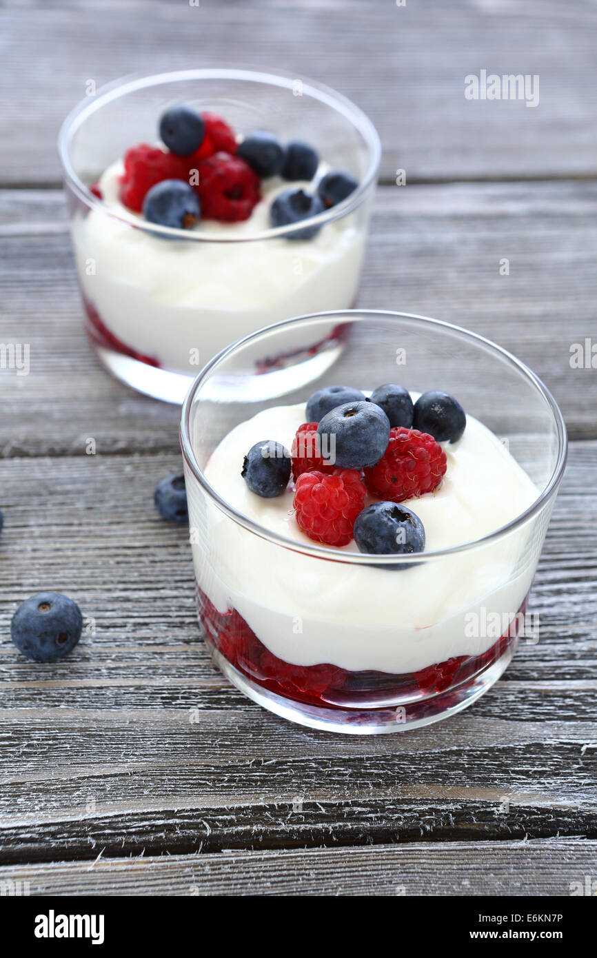 two glasses of yogurt with berries, food closeup Stock Photo