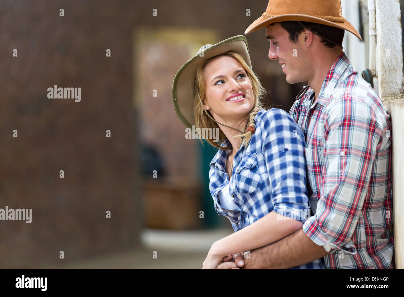 happy young farm couple embracing in stables Stock Photo - Alamy