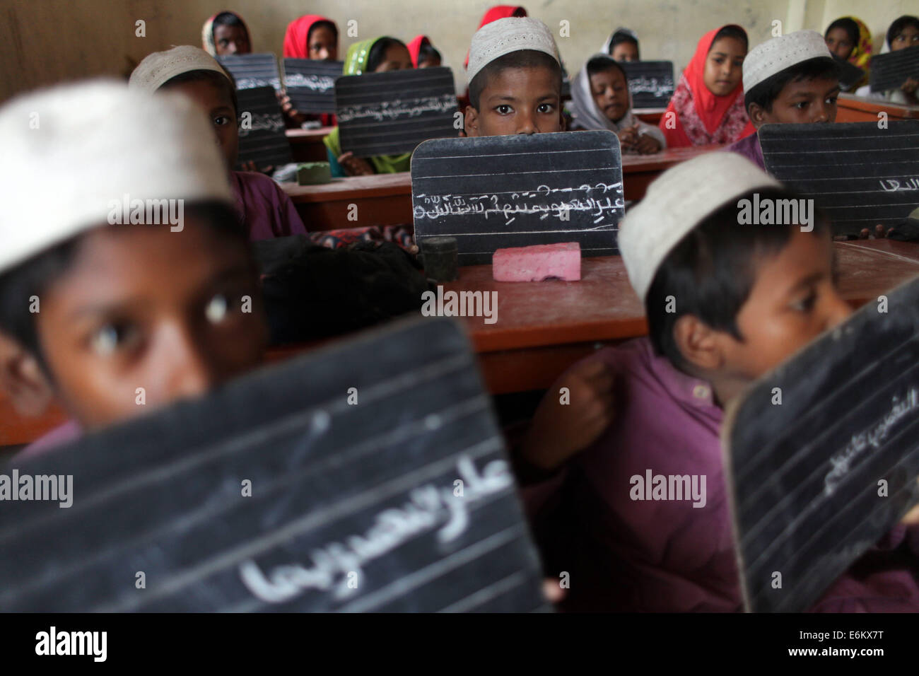 Dhaka, Bangladesh. 9th Sep, 2014. Bangladeshi students display their handwritings on their blackboards to their teacher at an Islamic education school on the outskirts of Dhaka © Zakir Hossain Chowdhury/ZUMA Wire/Alamy Live News Stock Photo