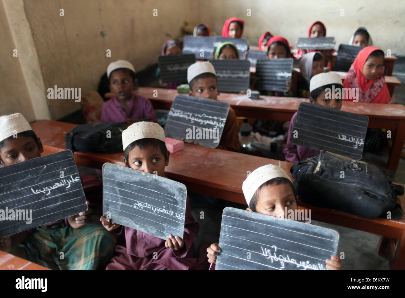 Dhaka, Bangladesh. 9th Sep, 2014. Bangladeshi students display their handwritings on their blackboards to their teacher at an Islamic education school on the outskirts of Dhaka © Zakir Hossain Chowdhury/ZUMA Wire/Alamy Live News Stock Photo