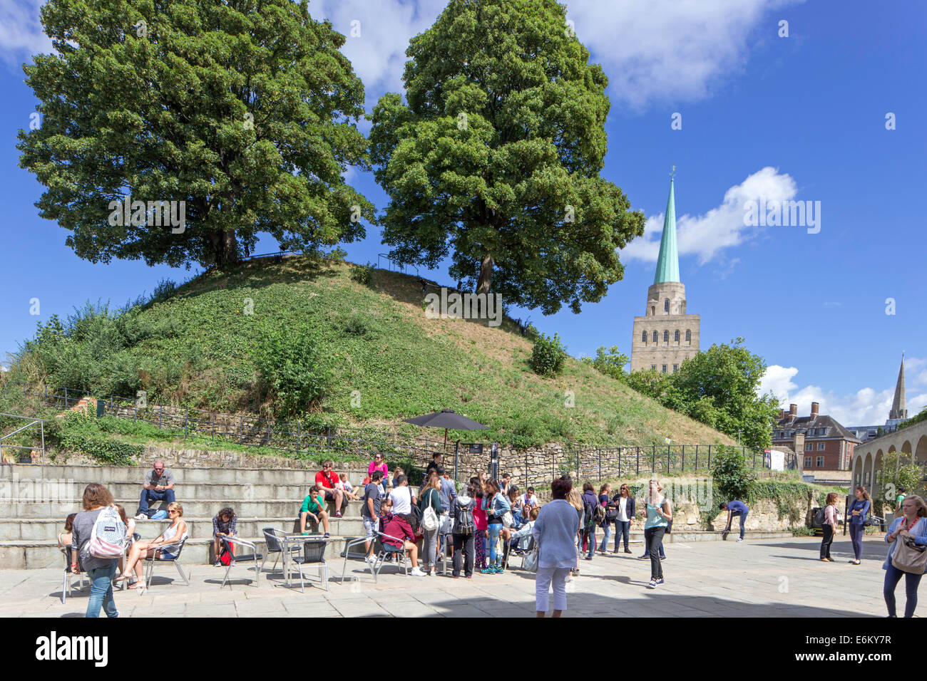 Tourists in the grounds of Oxford Castle with the spire of  Nuffield in the distance, Oxford, England, UK Stock Photo