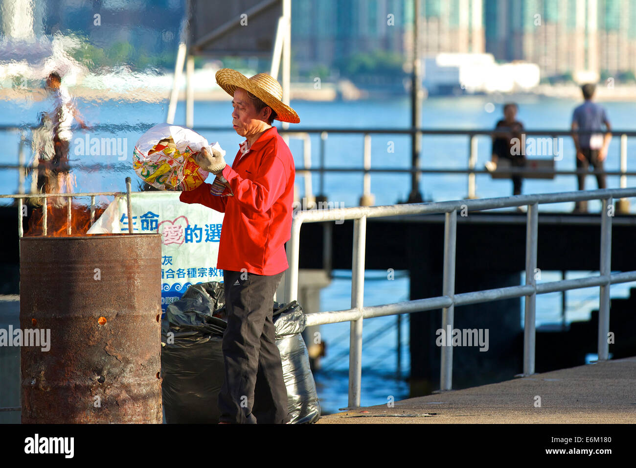 Chinese Cleaner In A Straw Hat Burning 