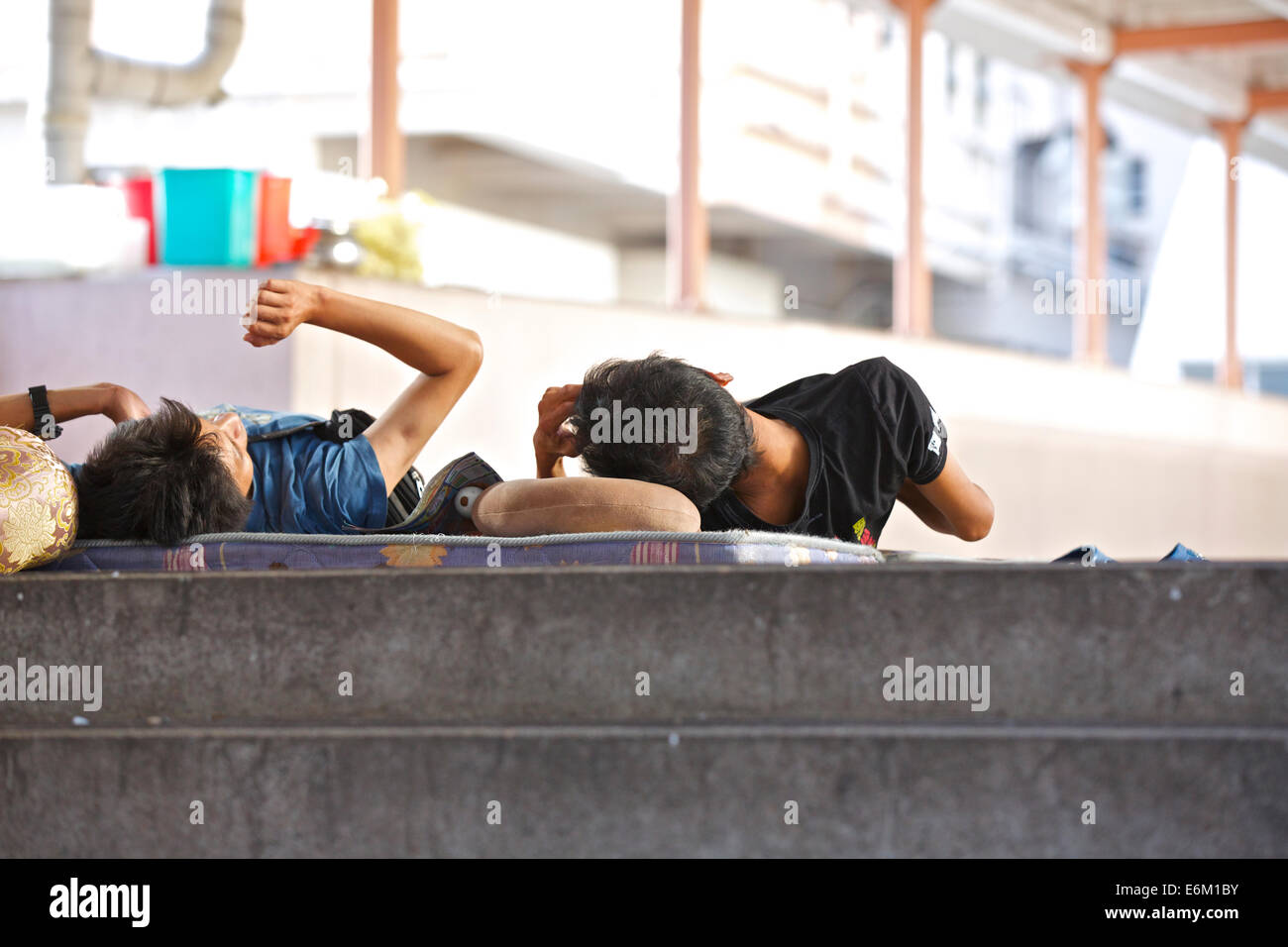 Sleeping Rough On A Pedestrian Overpass In North Point, Hong Kong. Stock Photo